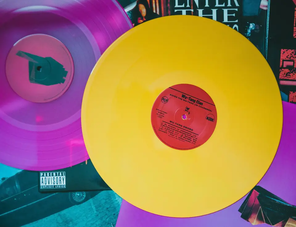 a yellow and purple record on a table
