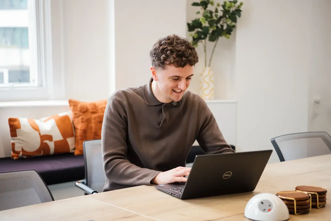 a man sitting at a desk with a laptop