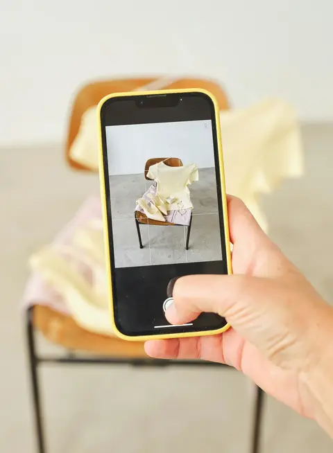 a person taking a picture of a chair