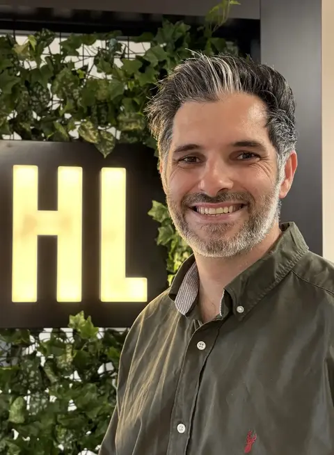 New IDHL member, Alex Wright, stood in the IDHL Leeds office
