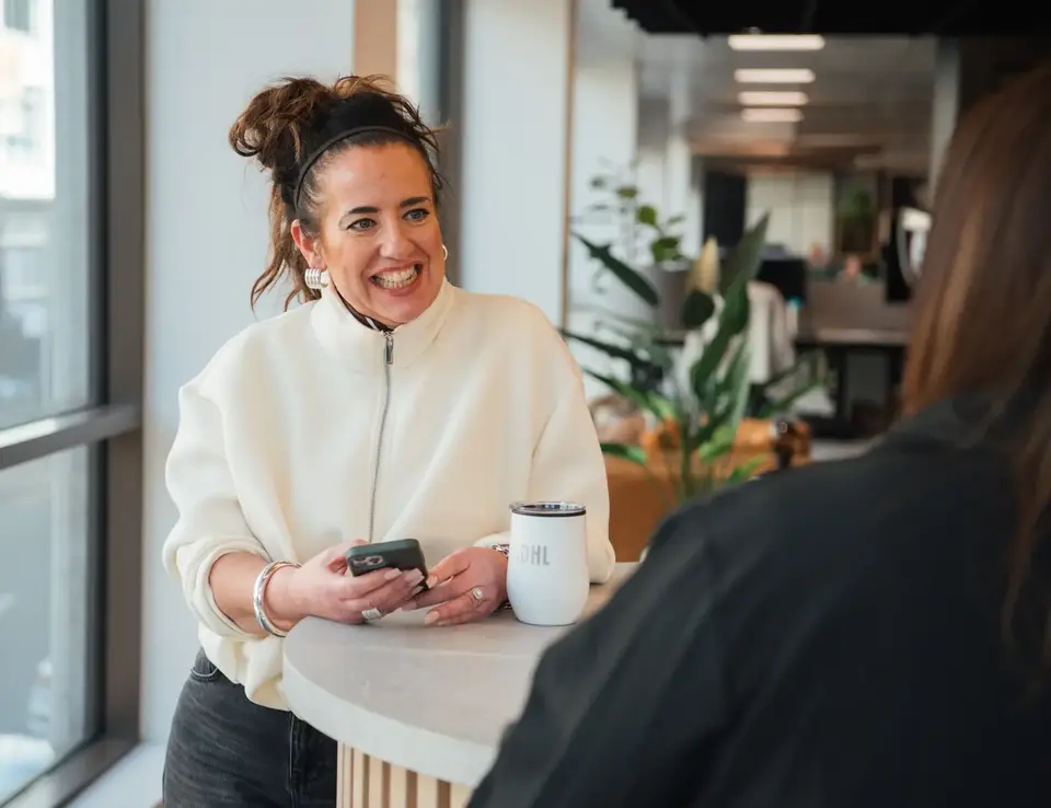a woman smiling at a table