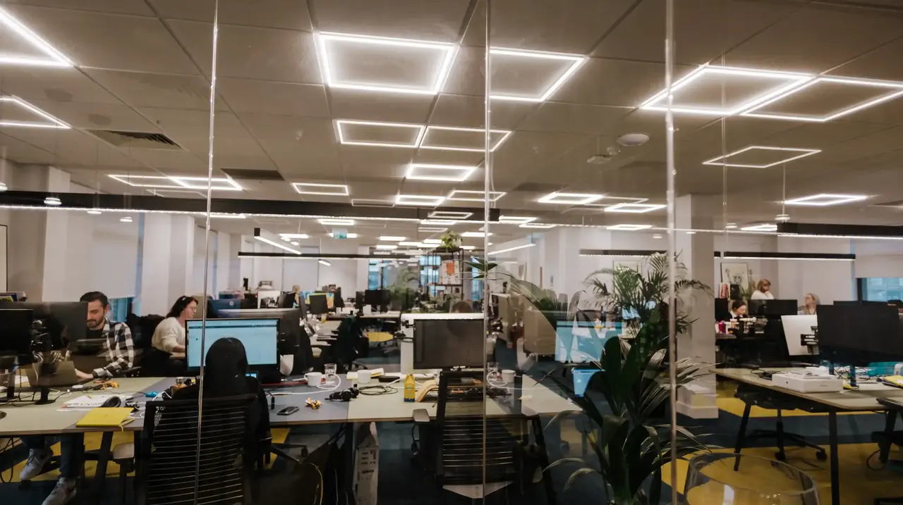 a group of people working at computers in an office