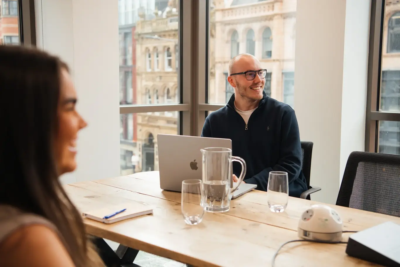 a man sitting at a table with a laptop